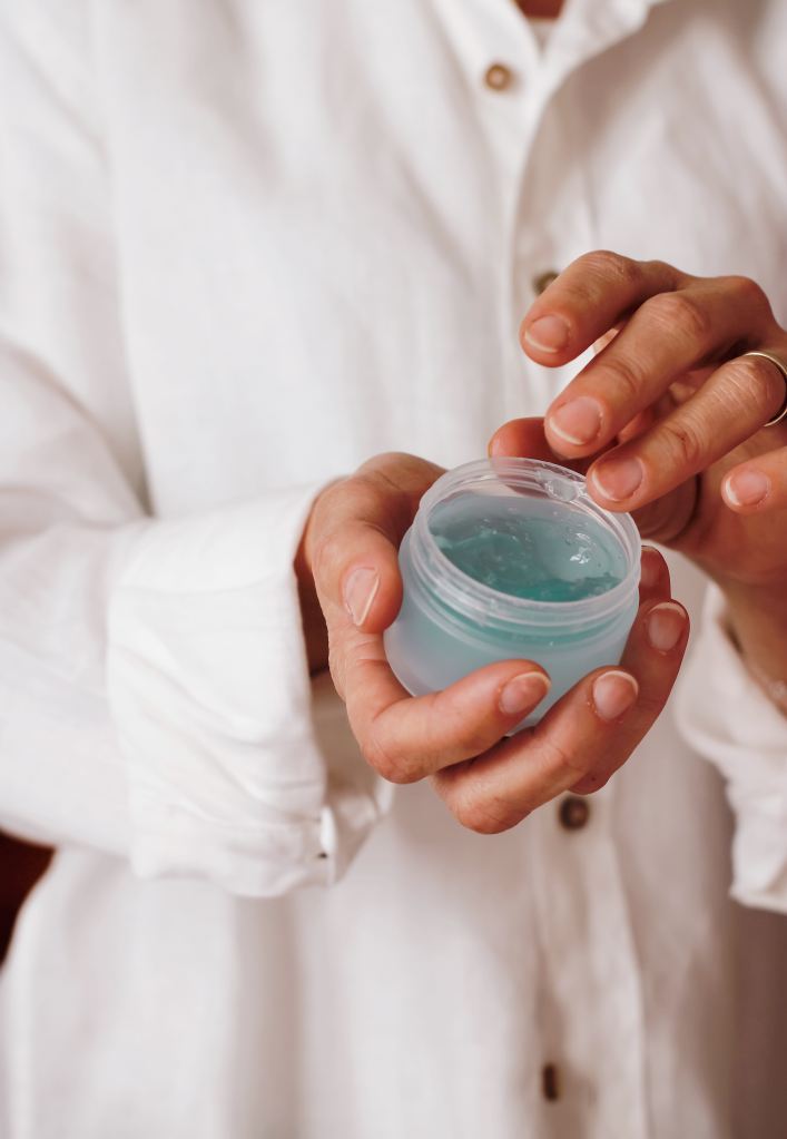 A person wearing a white button up shirt is holding a tub of light blue gel in their hands.

Pandora's Health blog